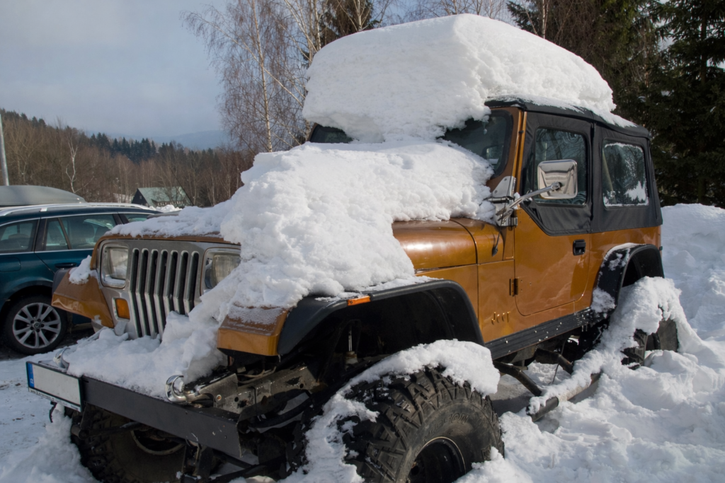 Jeep Wrangler with soft top under snow